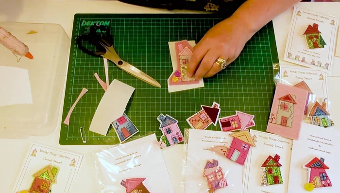 Attach the felt house to the brooch base.