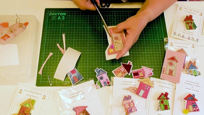 Trim excess brooch base material, leaving a clean edge around the house.