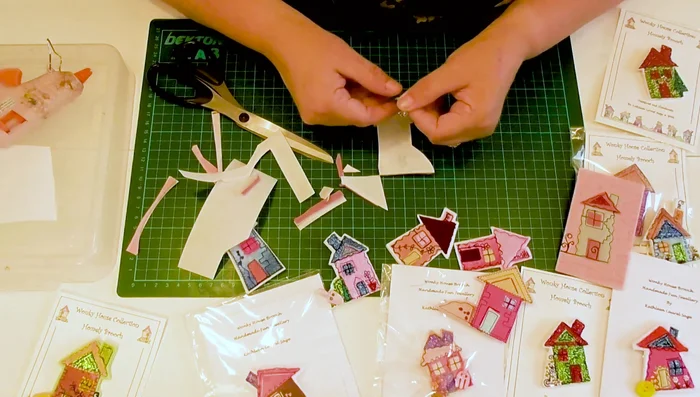 Attach the brooch pin using hot glue, ensuring a strong bond.