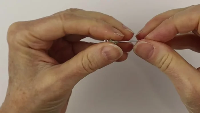 Optional: Add a bead to the hook by creating a head pin with wire, adding the bead, and forming a loop at the top to attach it to the hook.