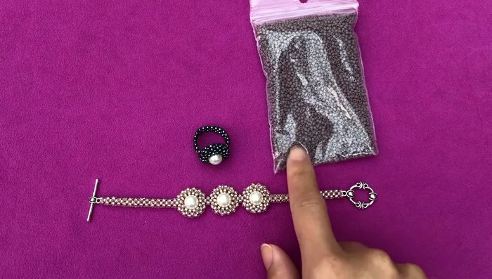 Prepare materials: Gather seed beads, pearls, thread, needles, and scissors.