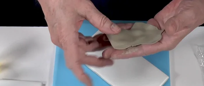 Remove the clay pieces carefully from the cutting mat.