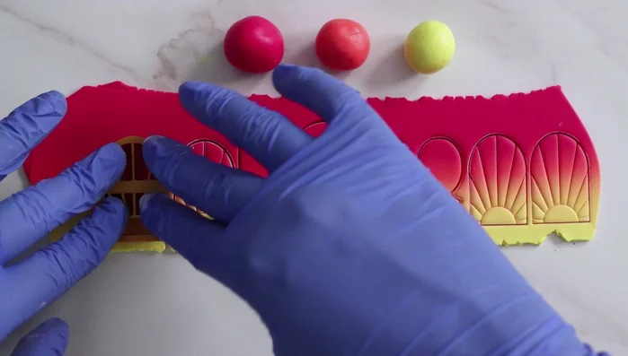 Cut out desired shapes using clay cutters.