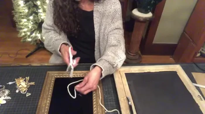 Prepare the jewelry: Remove clasps and earring backs from old jewelry pieces using wire cutters. Lay out your jewelry pieces on the fabric-covered foam core to design your Christmas tree shape. Take a photo of the layout if possible for reference.