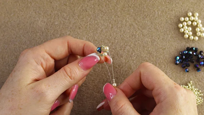 Continue the spiral: Repeat steps 4 and 5, adding rows of beads, ensuring each new larger bead sits on top of the previous one. Maintain tension using fingers to keep the spiral tight.