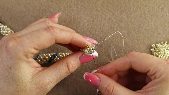 Secure the clasp: Reinforce the clasp by going through beads multiple times to ensure it's secure.