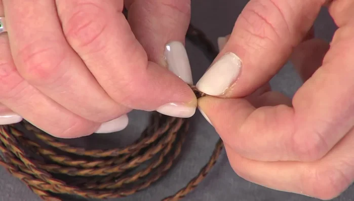 Prepare the cord ends by stacking them to fit the round end caps.