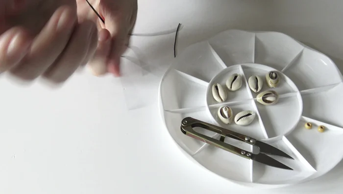 Prepare the cords: Cut two longer cords (slightly longer than your wrist) and one shorter cord for the sliding knot.