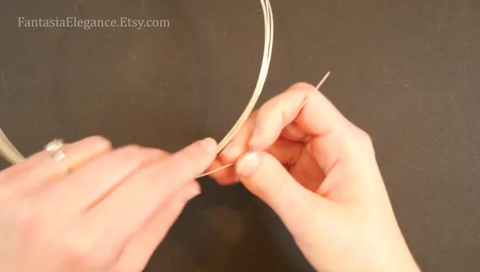 Secure the motif: Cut a 1-inch (2.8 cm) piece of 24-gauge wire, bend it in half, and wrap it around the join between the two spirals to secure them.