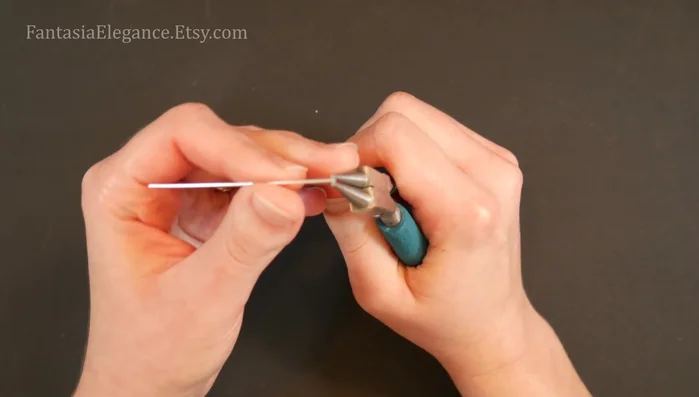 Secure the motif: Cut a 1-inch (2.8 cm) piece of 24-gauge wire, bend it in half, and wrap it around the join between the two spirals to secure them.