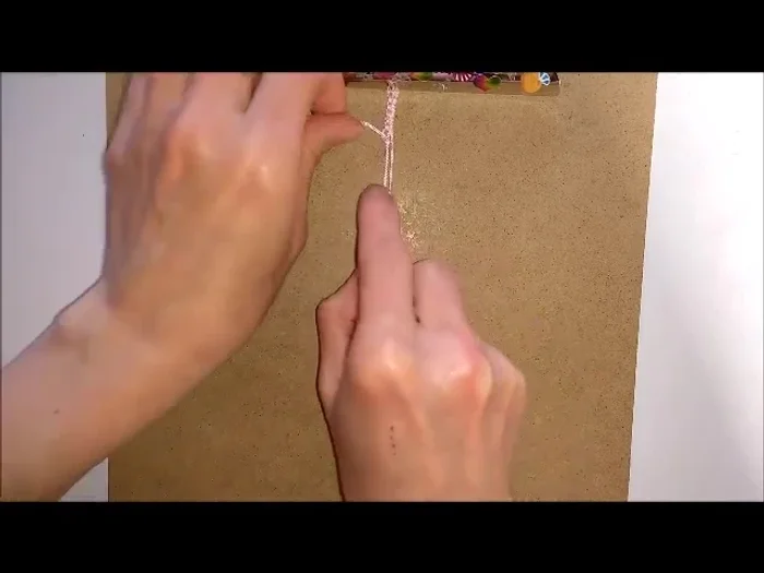 Push the bead up to the hitch knots.