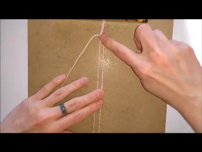 Push the bead up to the hitch knots.