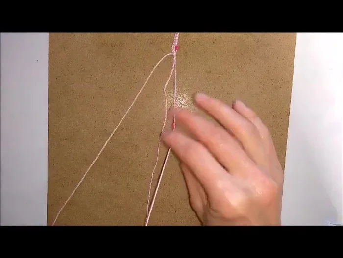 Repeat steps 6-10, adding beads and making hitch knots until the anklet reaches the desired length.