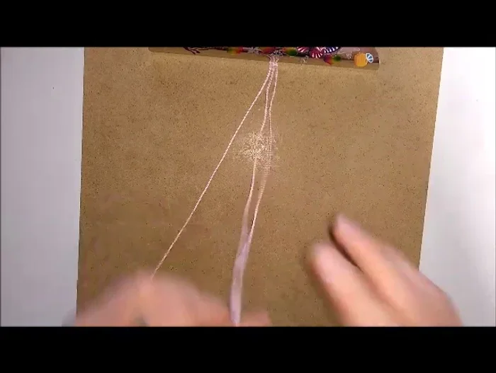 Arrange the two shorter ends on one side and the longest end on the other side of the board. Slightly separate the shorter ends and clip them to the bottom of the board.