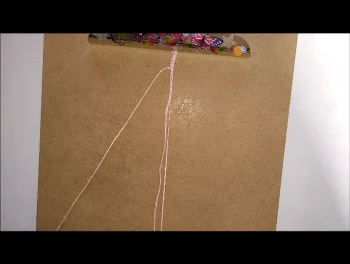 Push the bead up to the hitch knots.