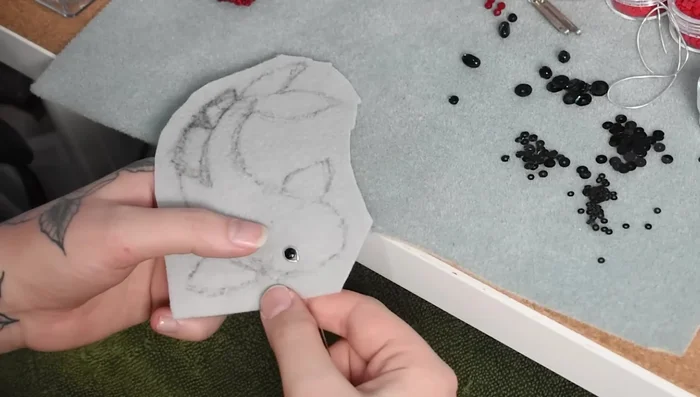 Attach the eye using a black bead and silver wire.