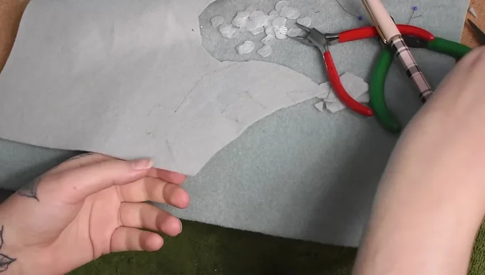 Attach the pinback, then cover the back with a final piece of felt using blanket stitch.