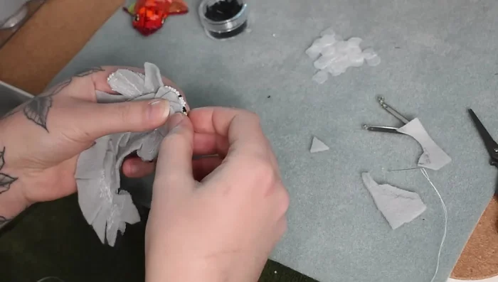 Whip stitch the tabs to secure the stuffing and create structure.