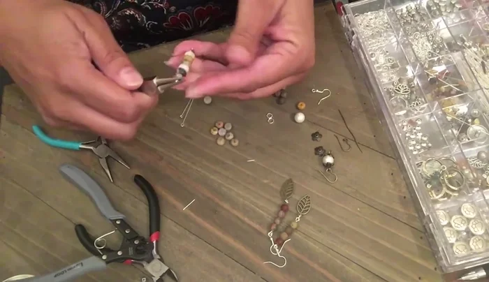 Attach a leaf charm to a jump ring.