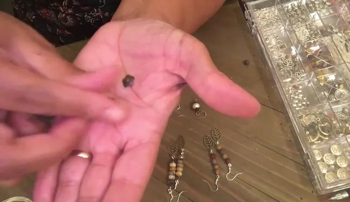 Attach a bead cap to each end of the wire, enclosing the pearl.