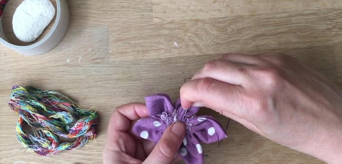 Close up the back of the flower with a few crisscross stitches.