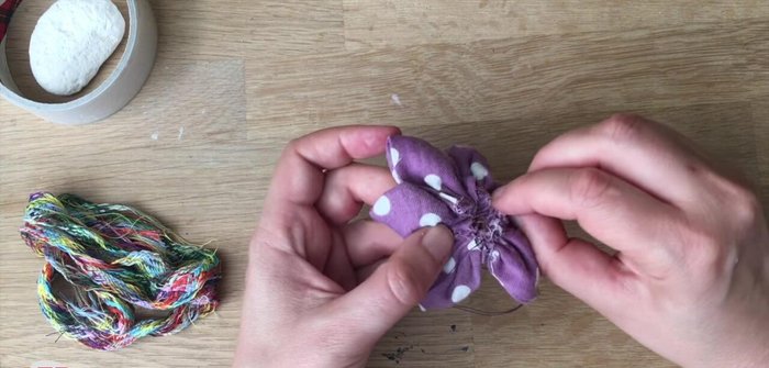 Close up the back of the flower with a few crisscross stitches.