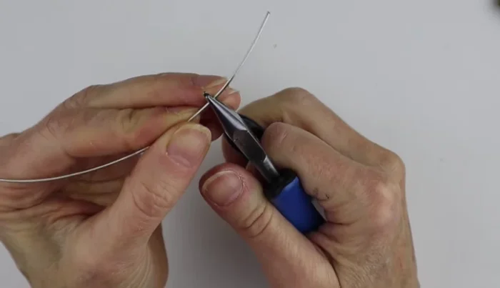 Bend a piece of wire at a 45-degree angle about an inch from the end. 