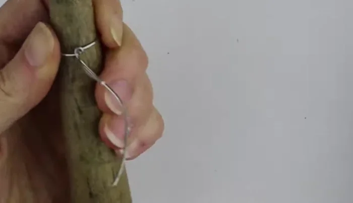 Twist the wire ends together and clip them flush against the ring. 