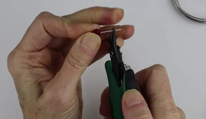 Attach a head pin with a charm to the loop.