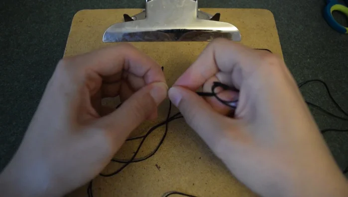 Tie another overhand knot to secure the braid. This forms one end of the anklet.