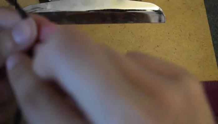 Tie another overhand knot to secure the braid. This forms one end of the anklet.