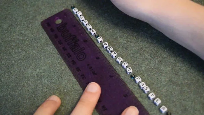 After each bead, tie two square knots to secure it. Repeat this process for all the beads.