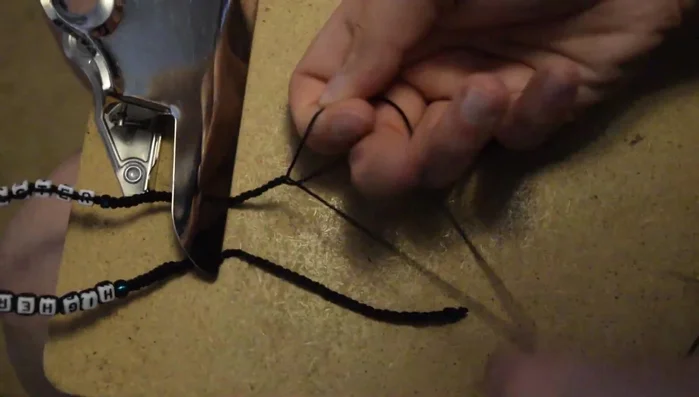 Tie another overhand knot, braid three more inches, and finish with an overhand knot.