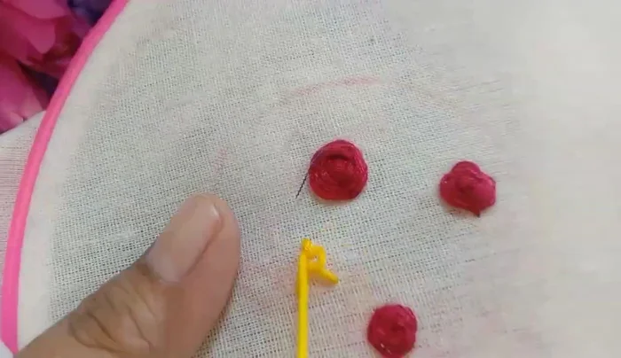 Embroider yellow roses using the same technique as the red roses.