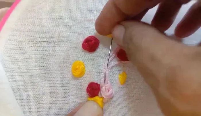 Embroider pink roses and buds.