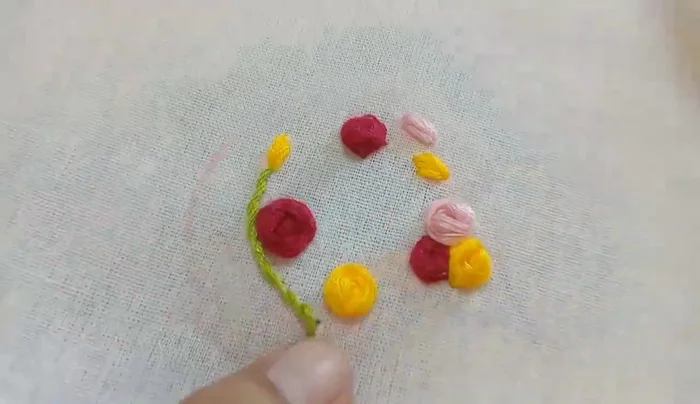 Add leaves using green and dark green thread.