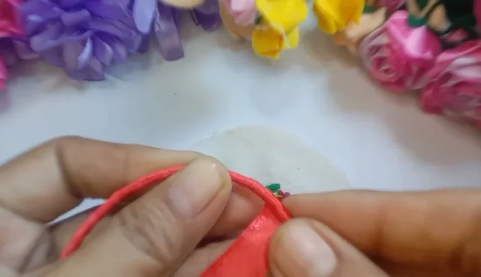 Measure and attach foam to the embroidered piece, securing it with rough stitches.