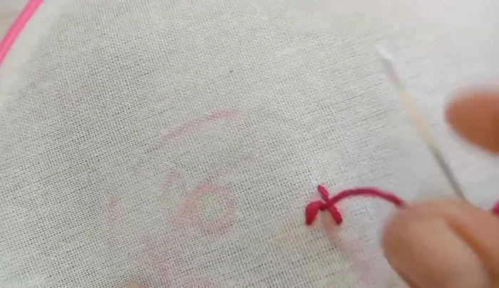 Embroider yellow roses using the same technique as the red roses.