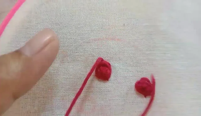 Embroider yellow roses using the same technique as the red roses.