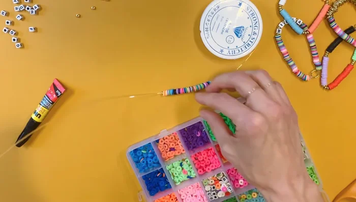 Add letter beads and gold accents as desired.