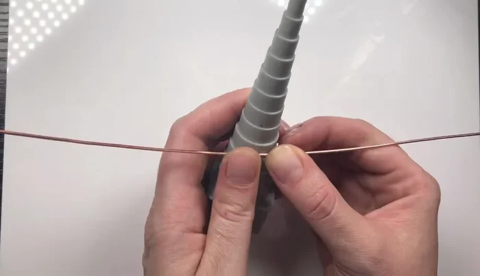 Hammer the guitar body gently to strengthen it without flattening the wire too much.