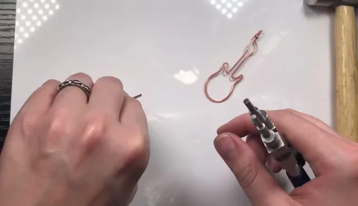 Weave the eye pin into the guitar head and neck using 26 gauge weaving wire. Adjust loop size if needed for a snug fit.