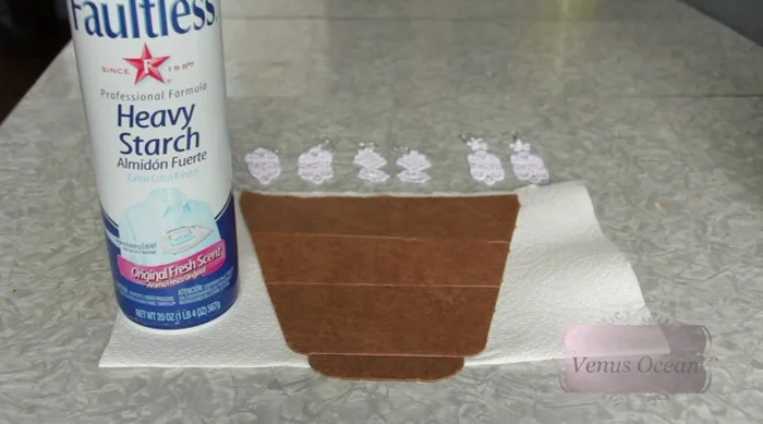 Lightly spritz the lace with heavy starch and iron to stiffen.