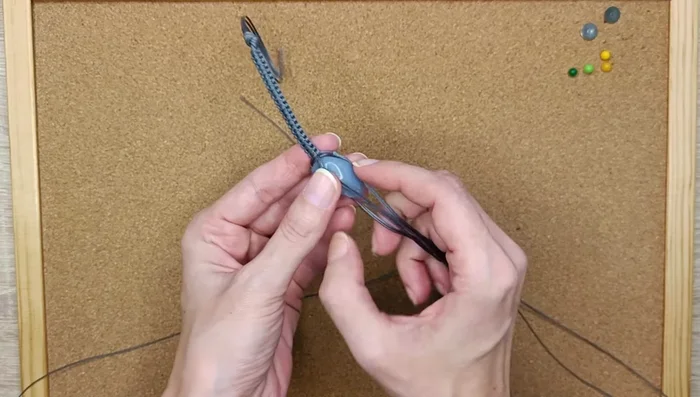 Insert the crystal into the created pouch and adjust its position.