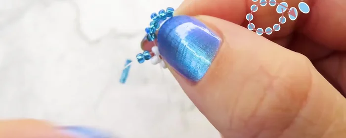 Tie two knots to secure the first flower.