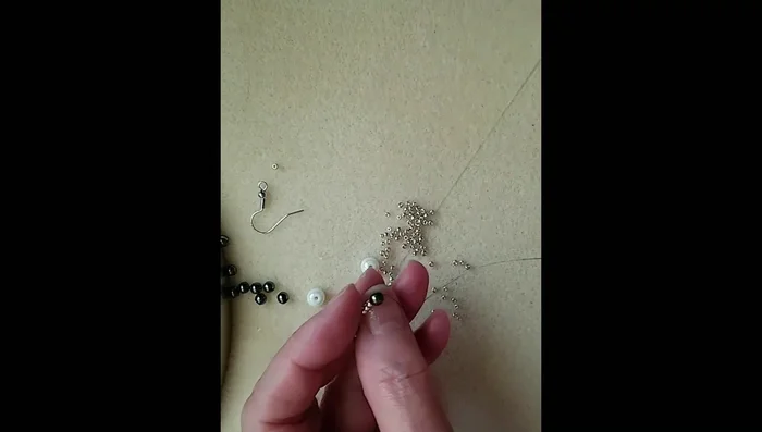 Repeat step 2 to make three similar loops, passing through the hematite bead in the middle.