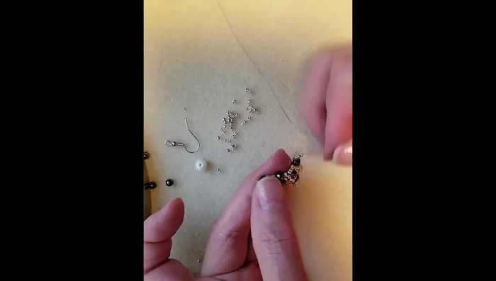 Pass the thread through the initial loops and secure the earring component.