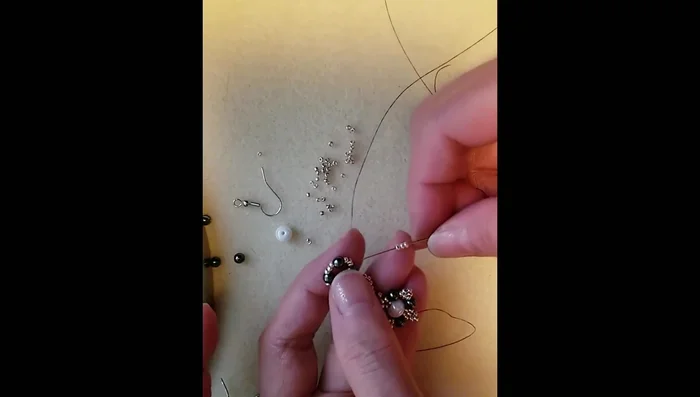 Add three size 11 seed beads, pass through the hematite bead, and repeat to create three more small loops.