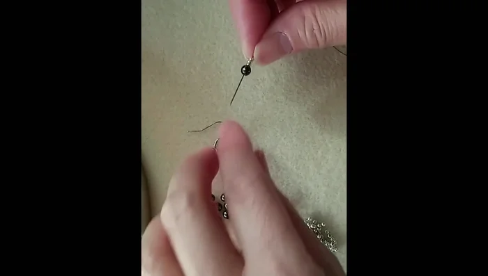 Repeat step 2 to make three similar loops, passing through the hematite bead in the middle.