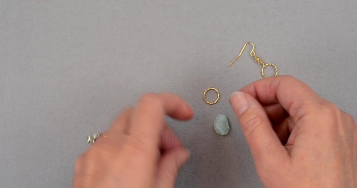 Prepare the head pin and gemstone: Slide the gemstone onto the head pin ensuring it's drilled top to bottom.